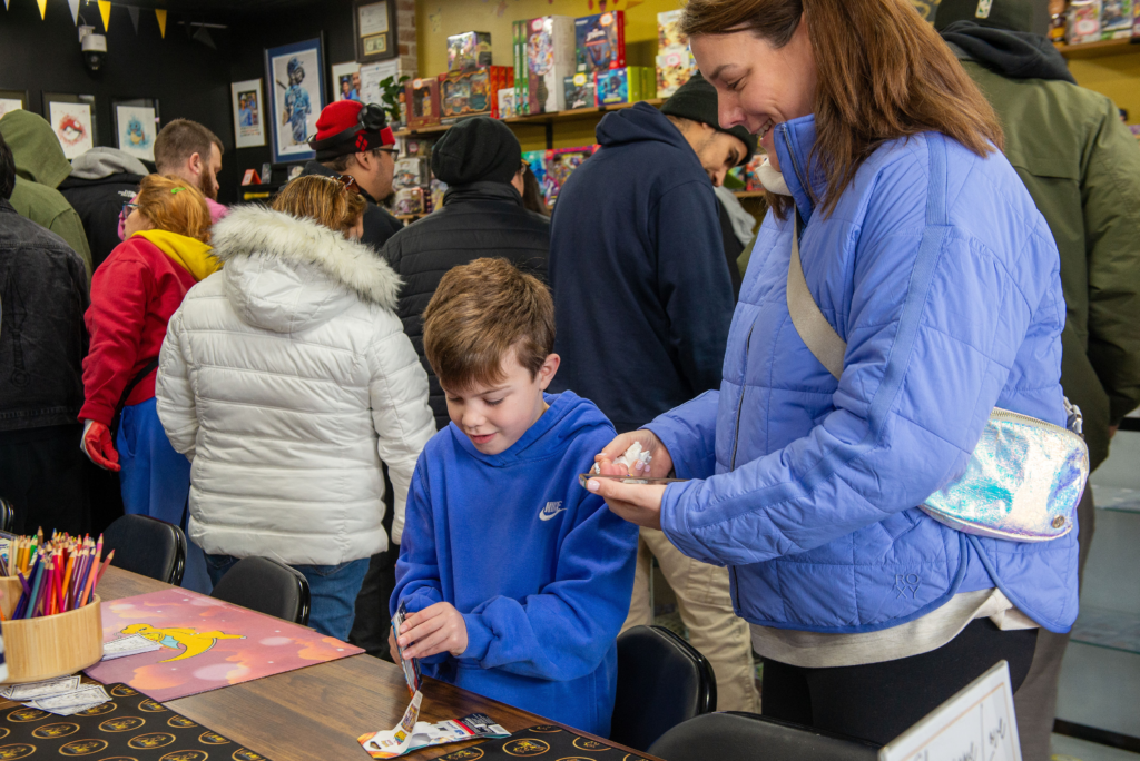 A younger collector opening a pack of cards