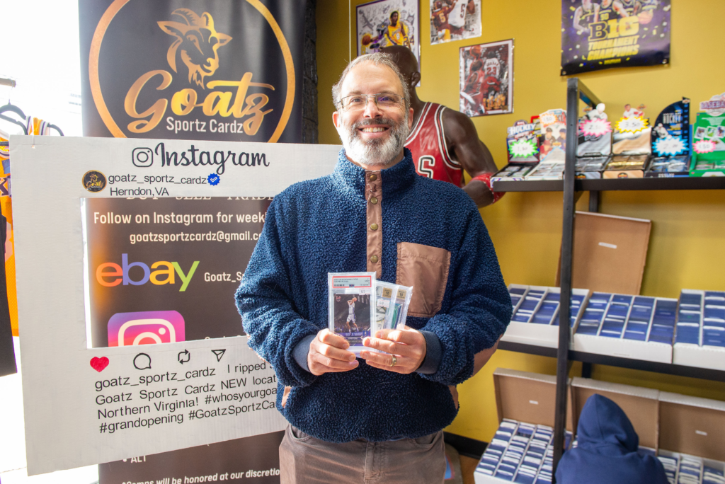 A customer showing off his first purchases at Goatz Sportz Cardz