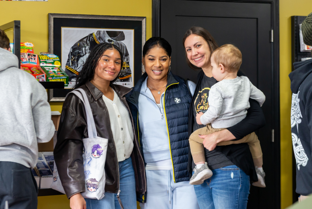 Customers at Goatz Sportz Cards with one of the owners