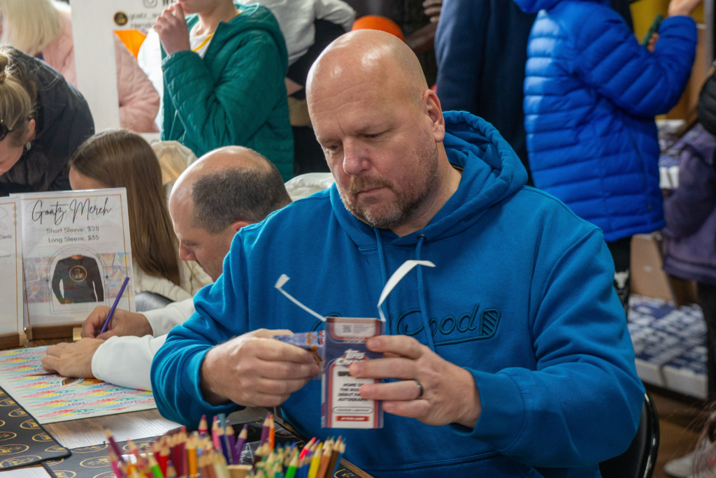 A customer opens a fresh box of cards looking for a great pull