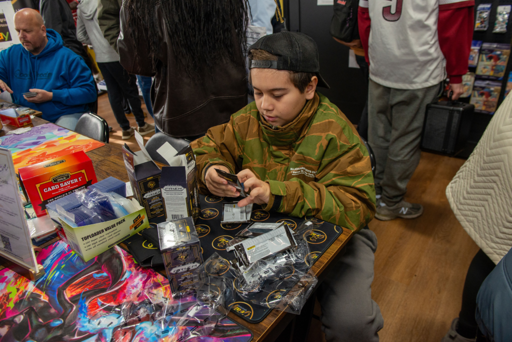 A younger collector ripping some packs at the Grand Opening