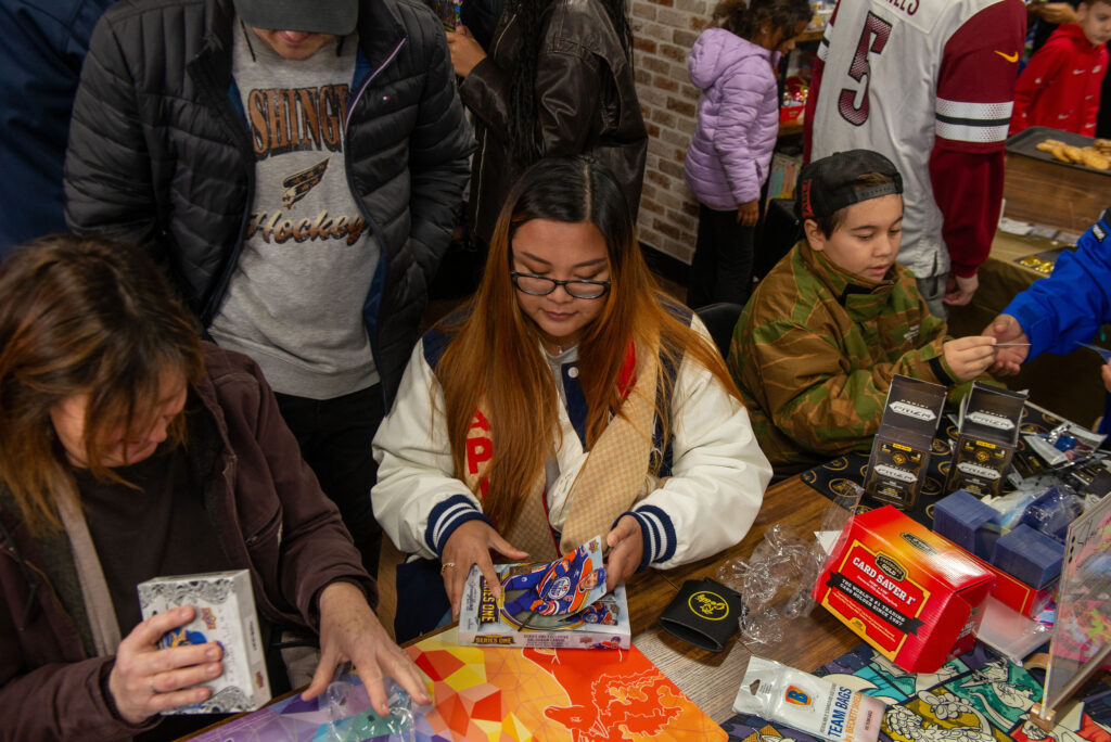 Customers ripping open some packs at the grand opening
