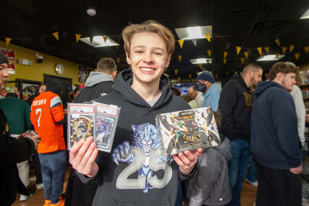A young football fan shows off his purchases