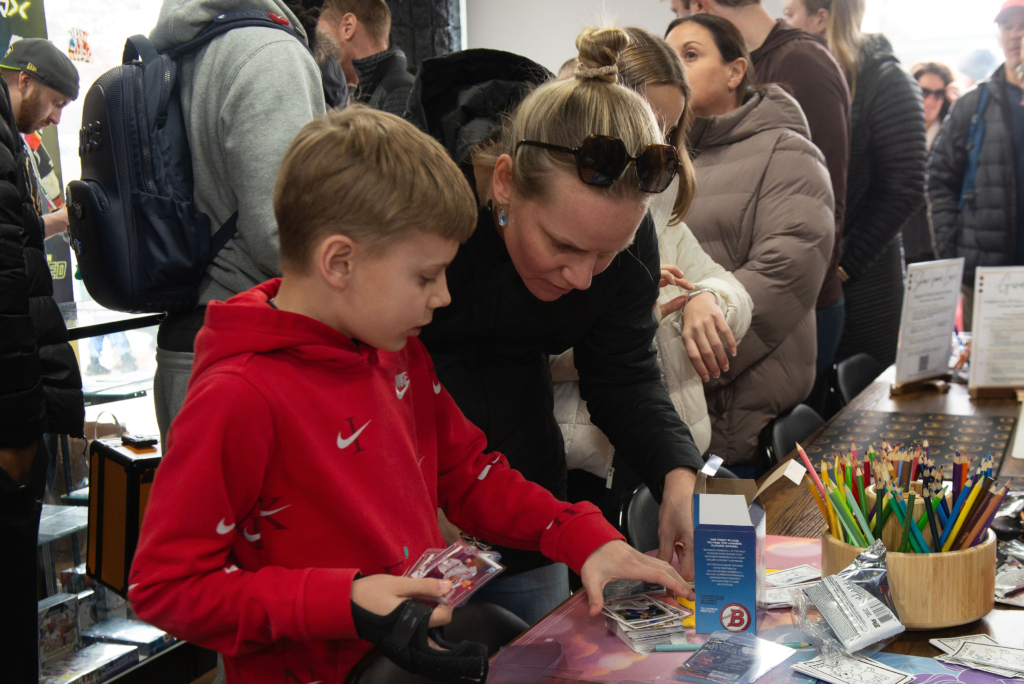 A mom and son opening up some cards