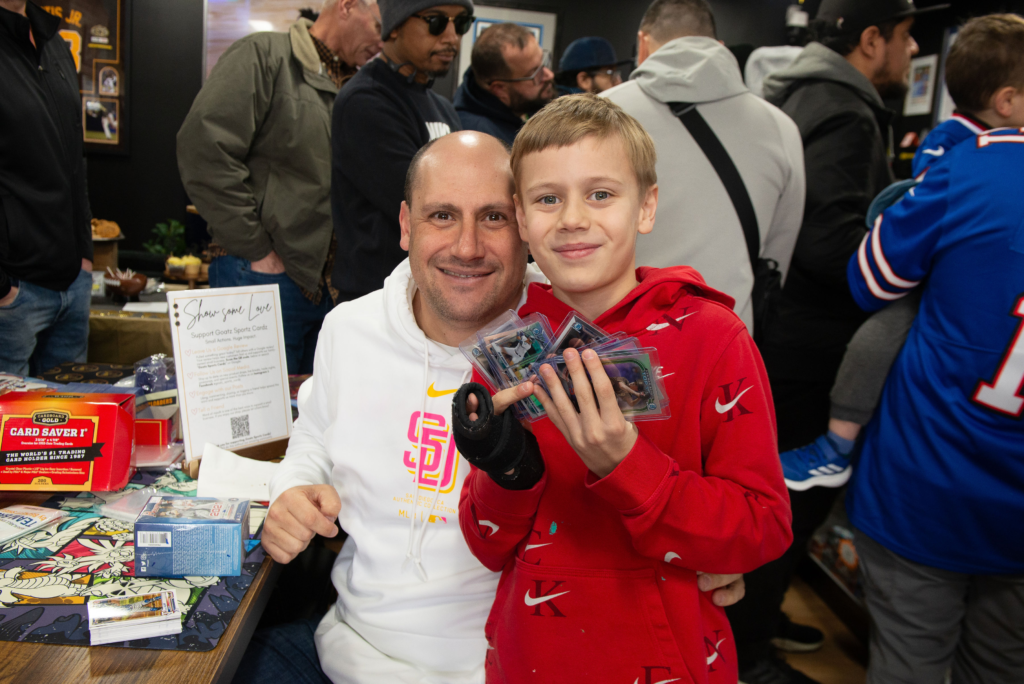 A dad and son opening up some packs and showing off their hits