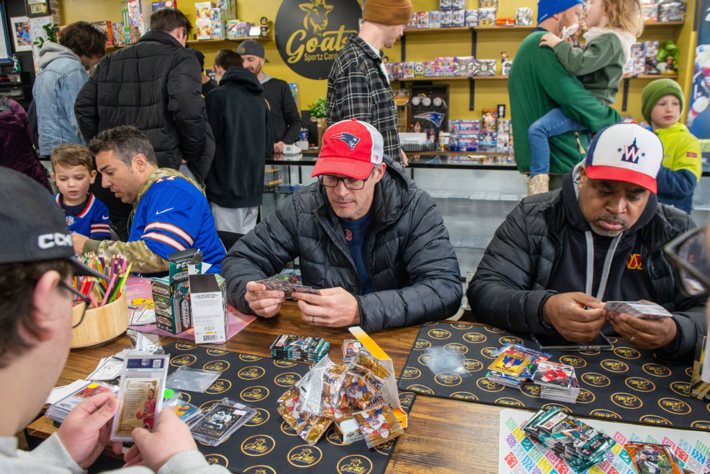 A packed table opening up packs of cards