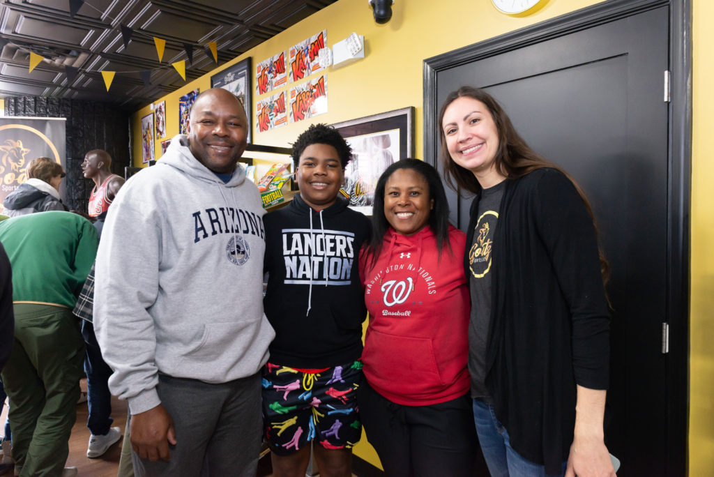 A family posing with one of the owners