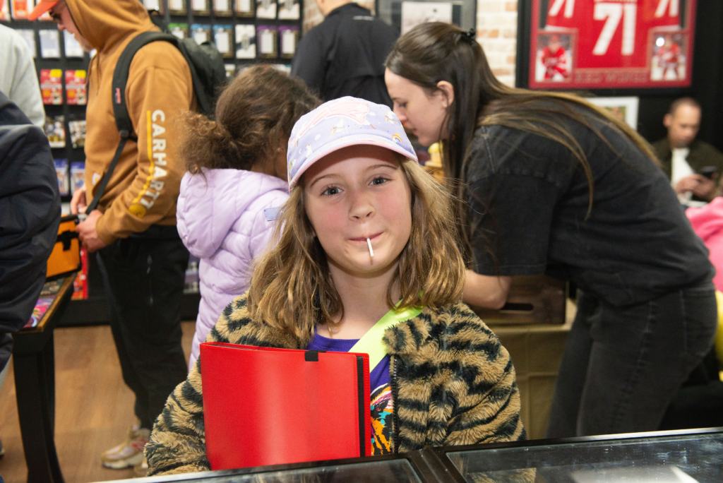A younger customer showing off her binder